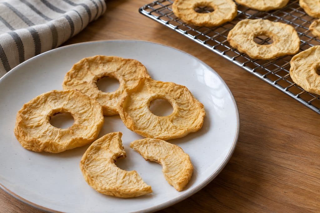 Cooled dried apple rings with a cut piece showing the interior